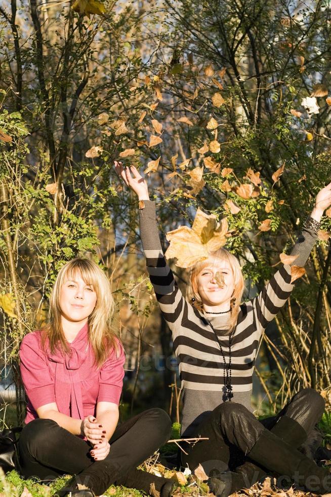 Two beauty young women in autumn park photo