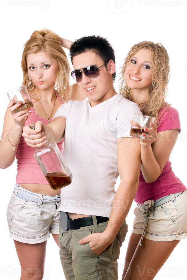 Cheerful young people with a bottle of whiskey photo