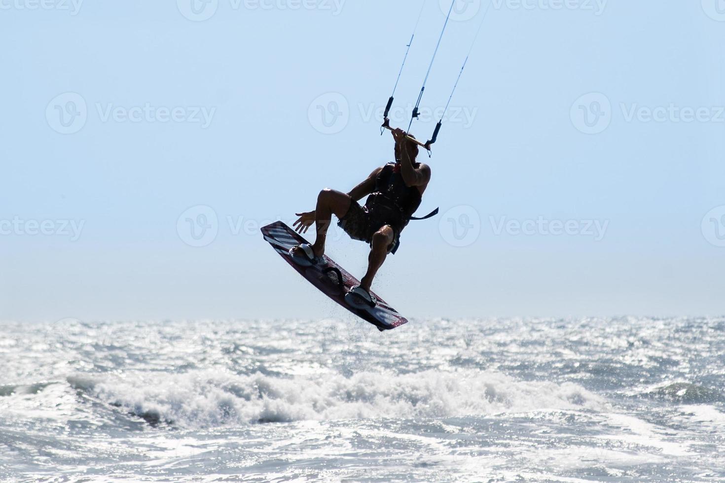 Silhouette of kite surfer photo