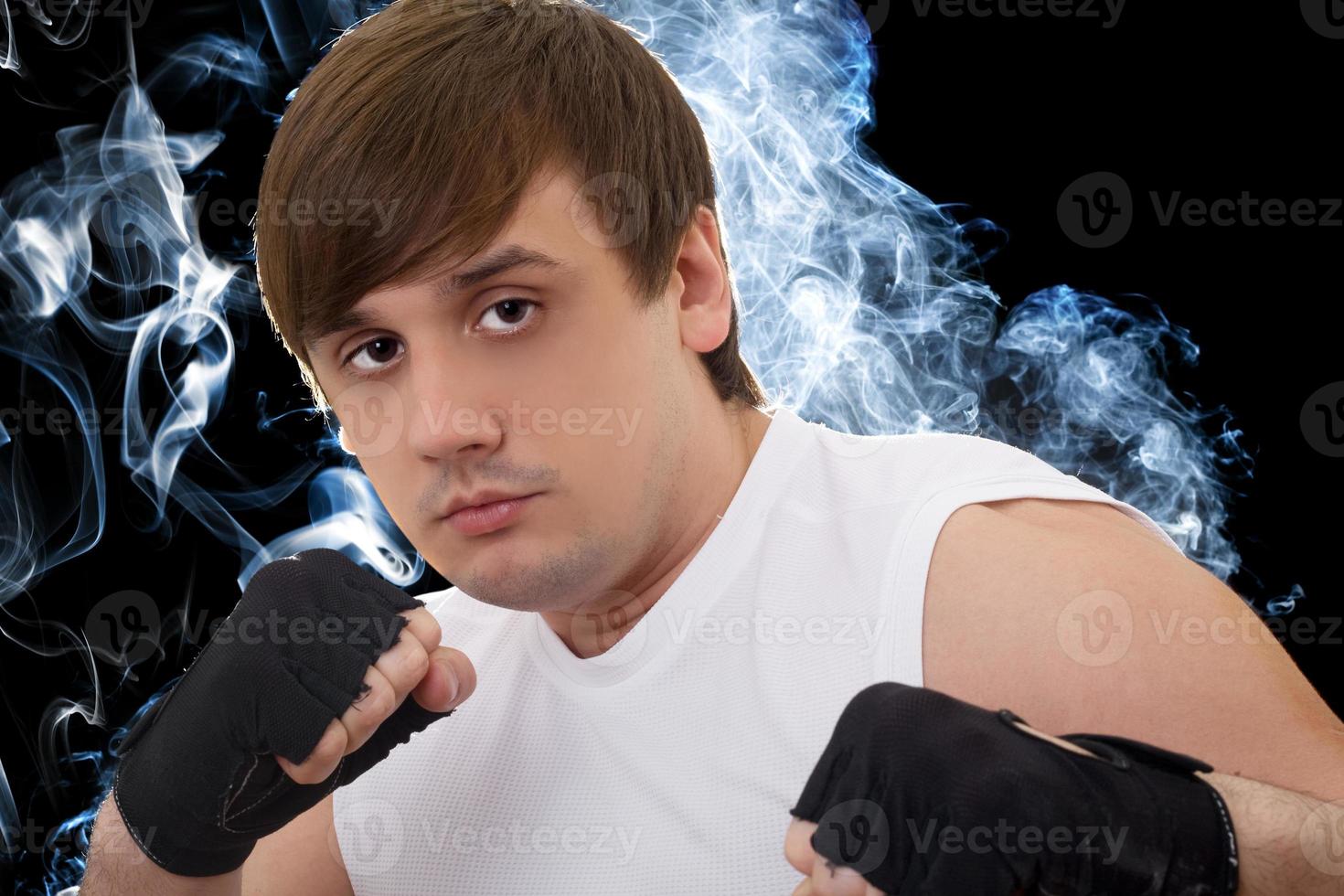 Portrait of the young fighter in a smoke photo