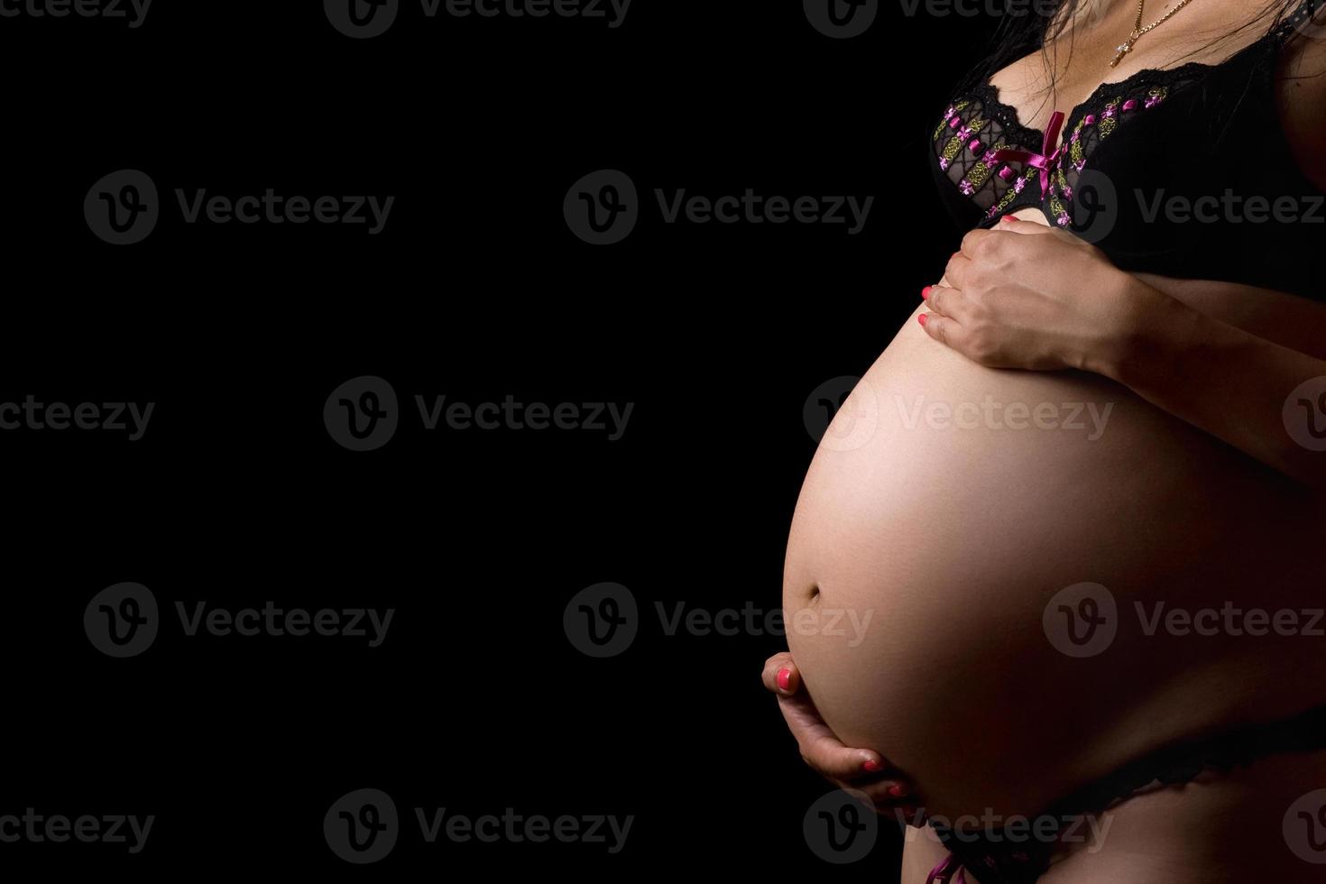 Belly of a pregnant young woman photo