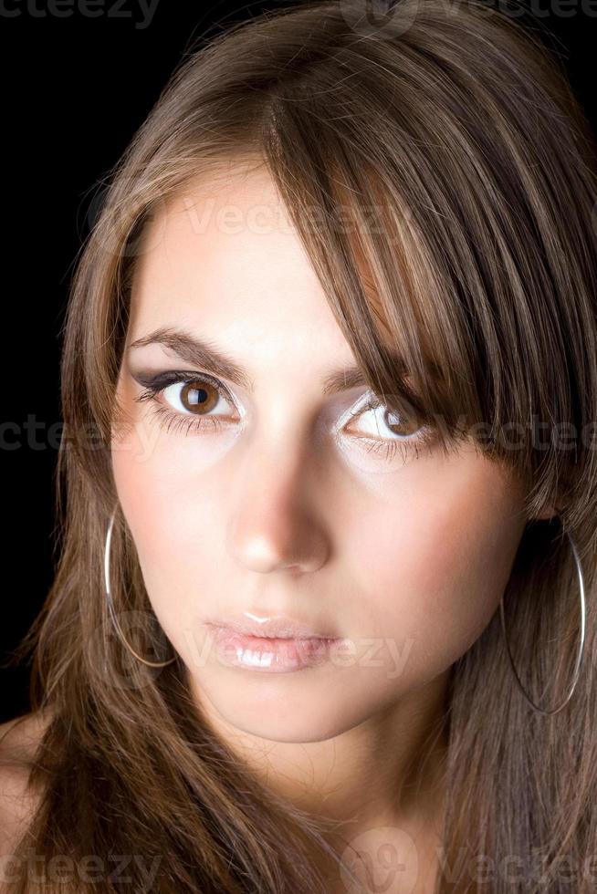 Portrait of the young woman. Isolated on black photo