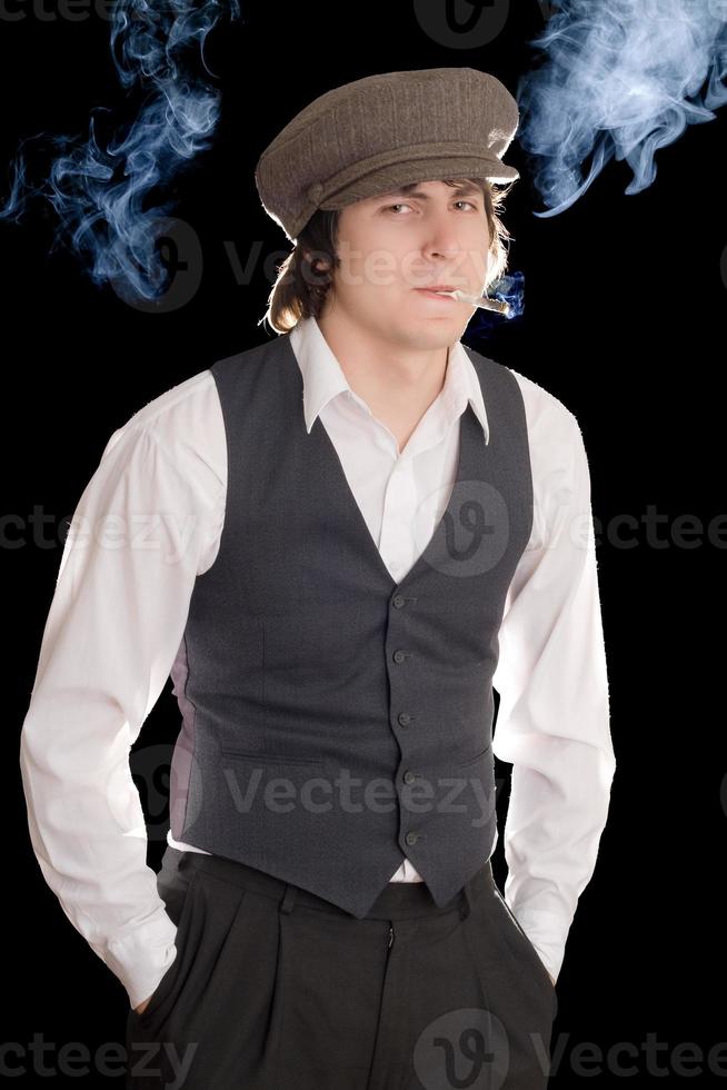 Young man smoking a cigarette in vintage clothes photo