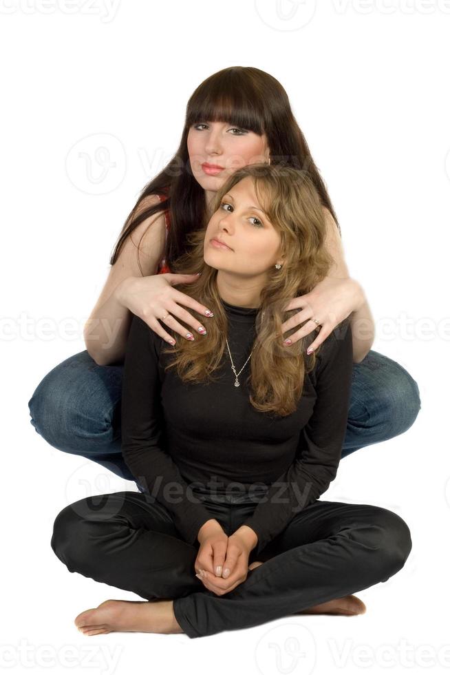 Two beauty young embracing women. Isolated. photo