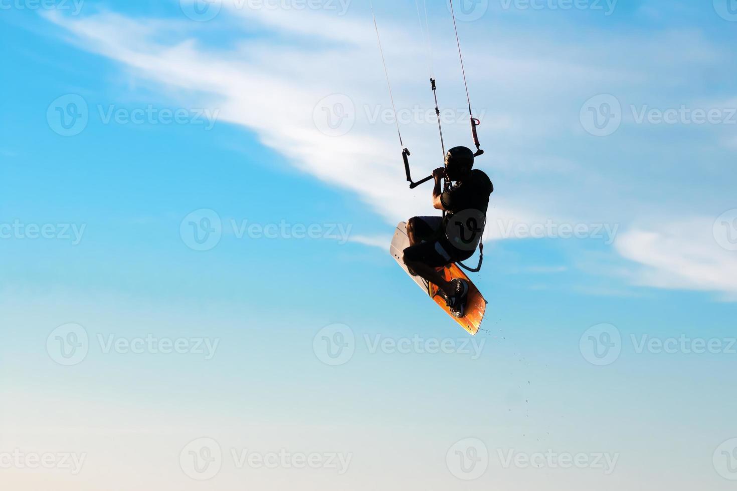 Silhouette of a kitesurfer photo