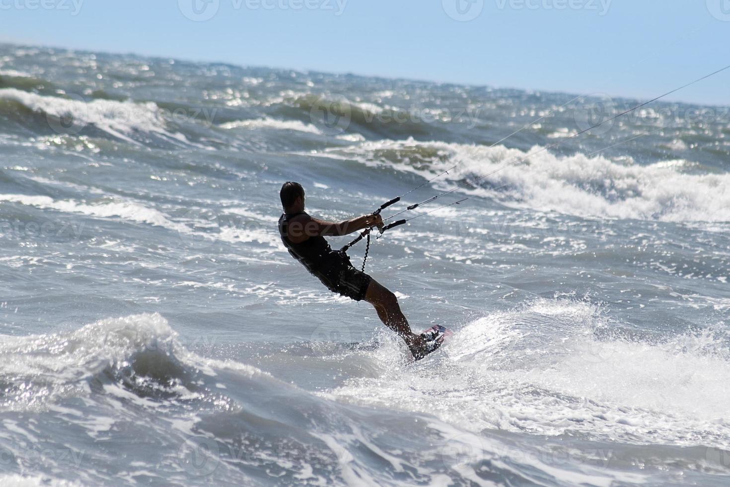 Silhouette of kite surfer photo