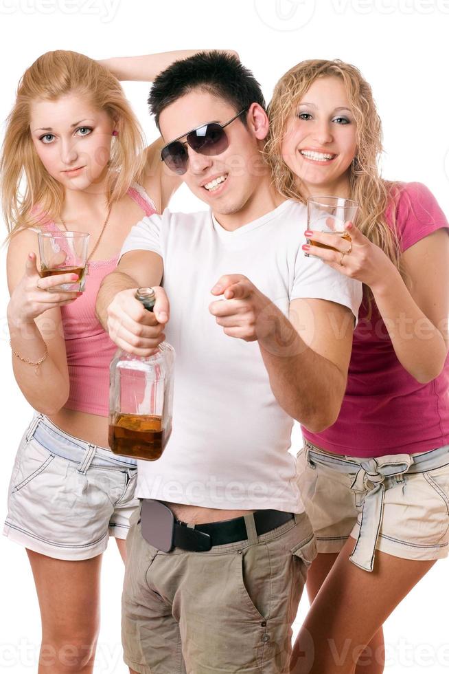 Happy young people with a bottle of whiskey photo