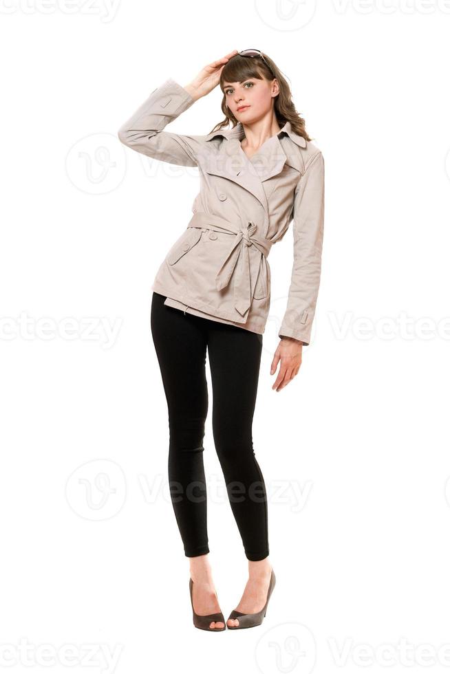 Beautiful girl wearing a coat and black leggings. Isolated photo