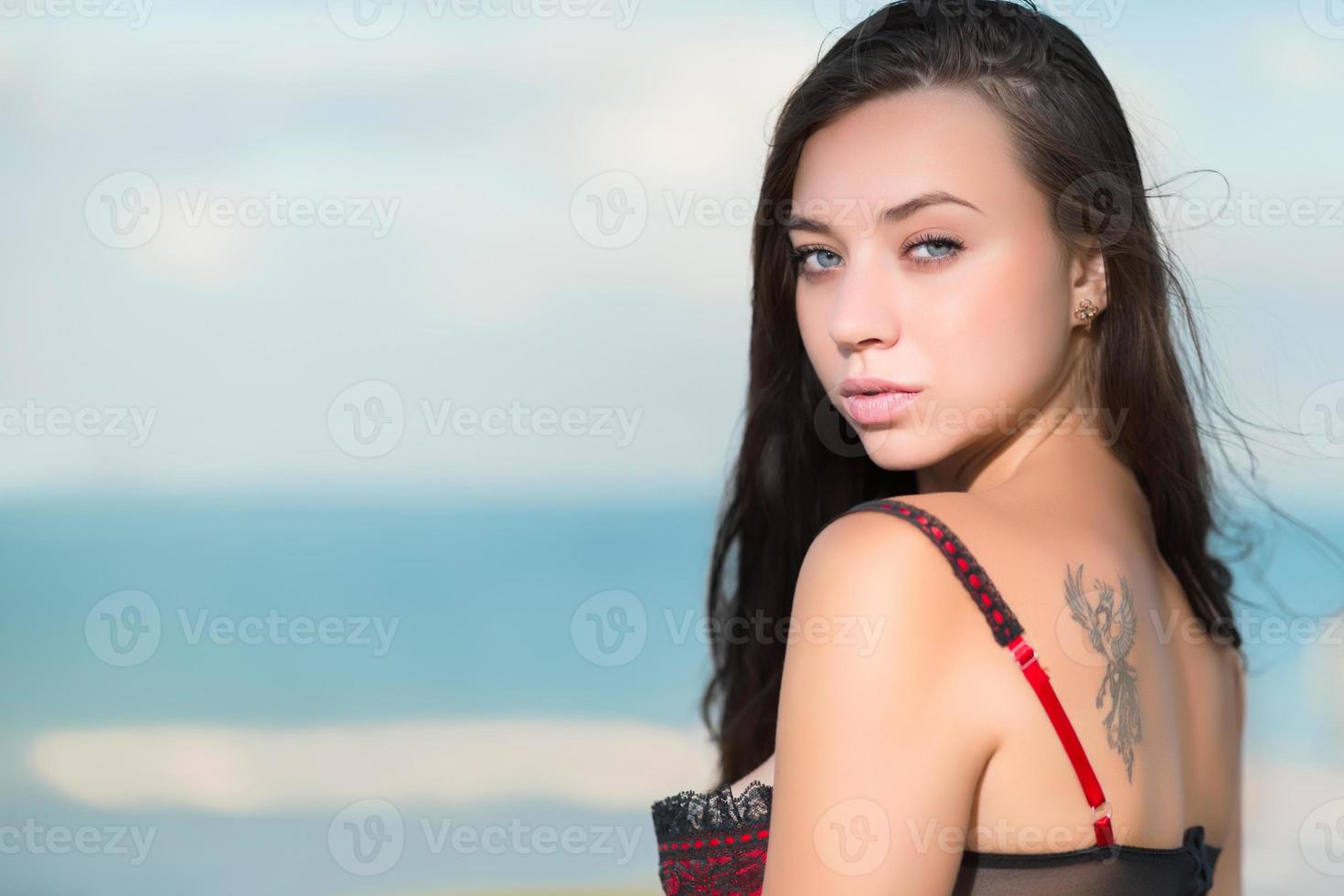 Portrait of sexy young woman with tattoo photo