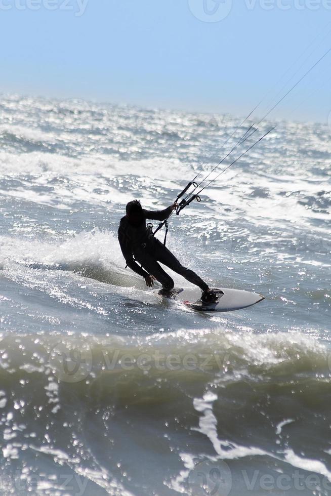 Silhouette of kite surfer photo