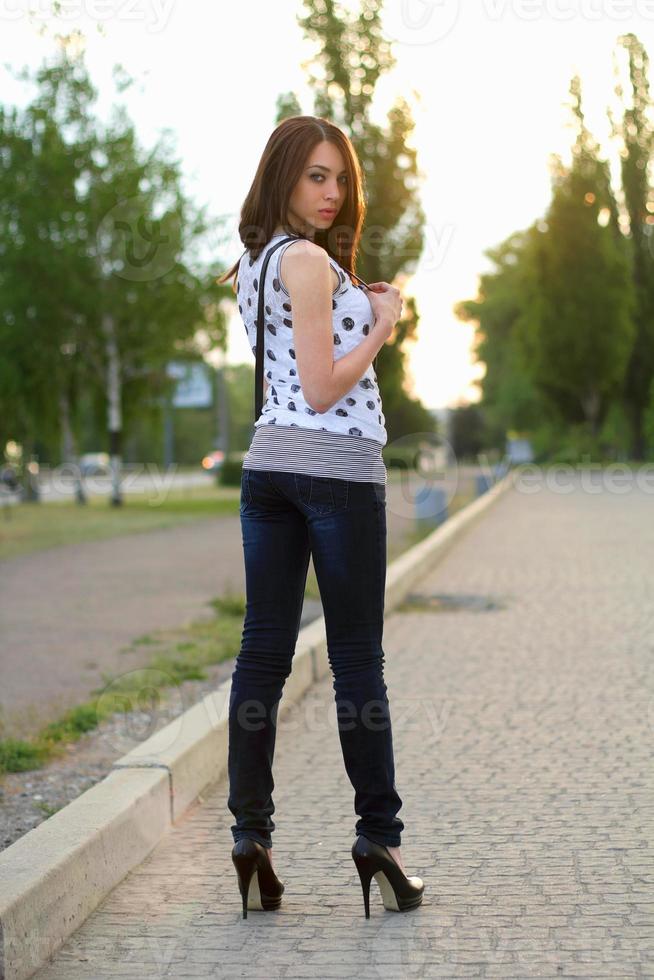 woman standing on the sidewalk photo