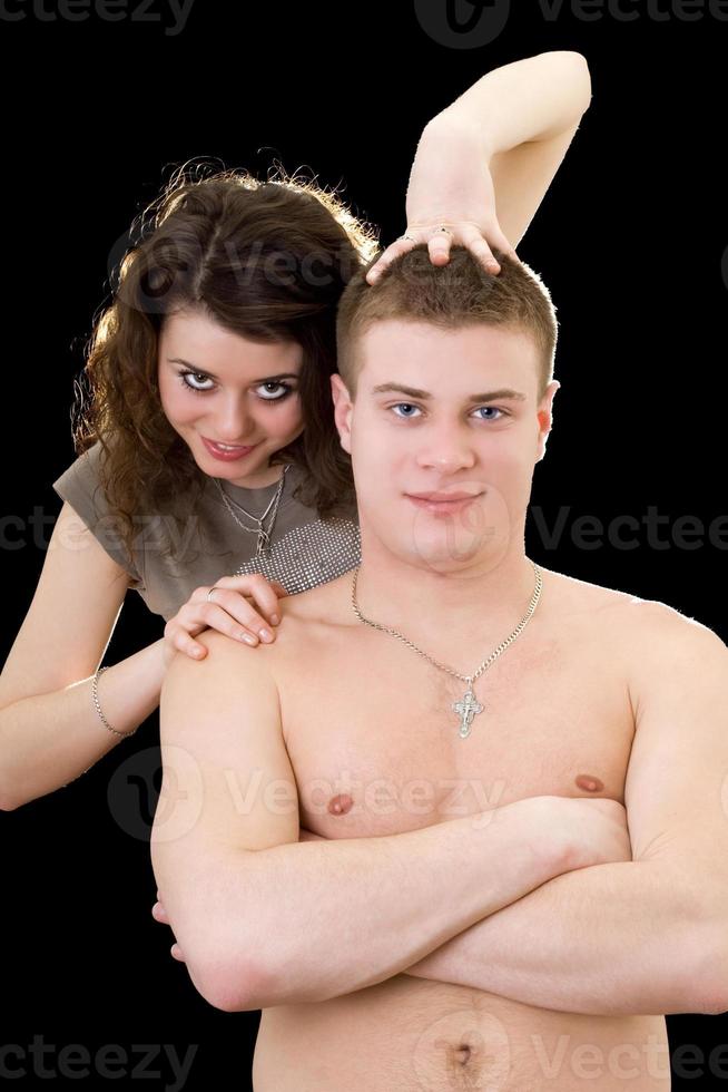 Beautiful playful young couple. Isolated on black photo