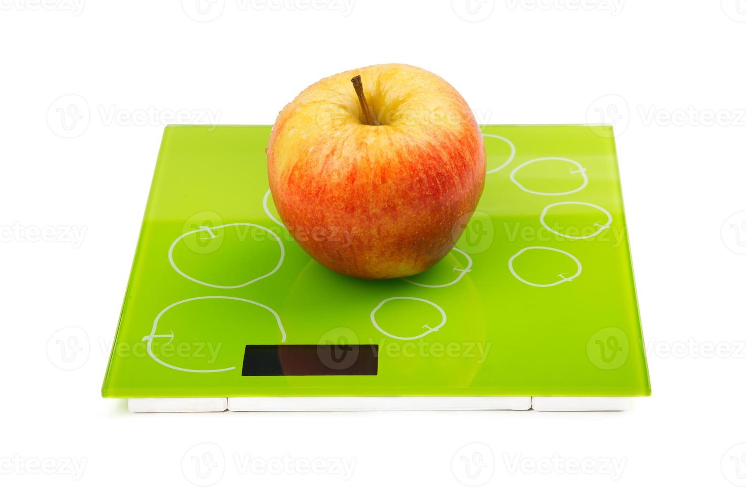 Red apple on scales photo