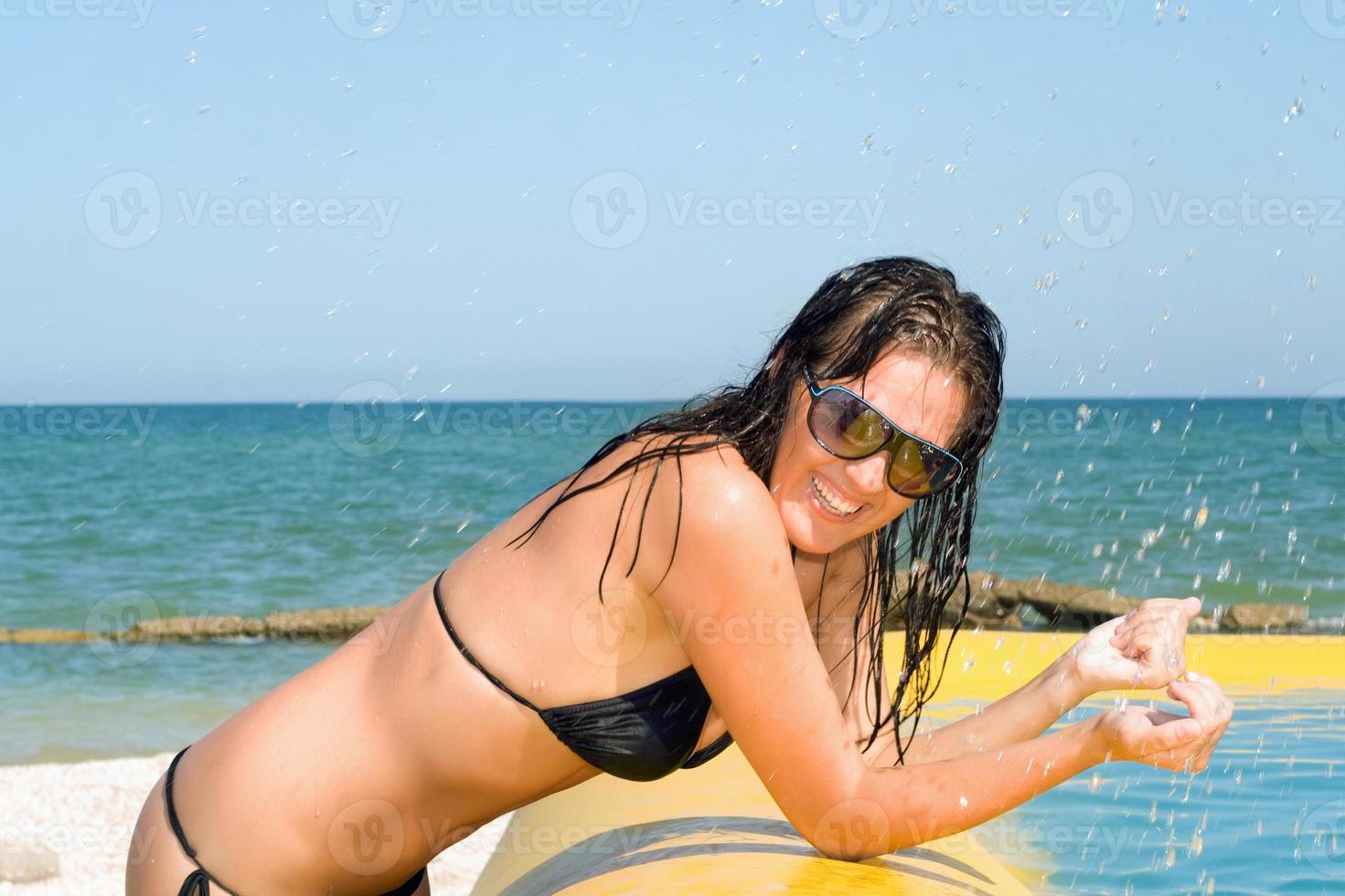 sexy young woman by the yellow pool photo