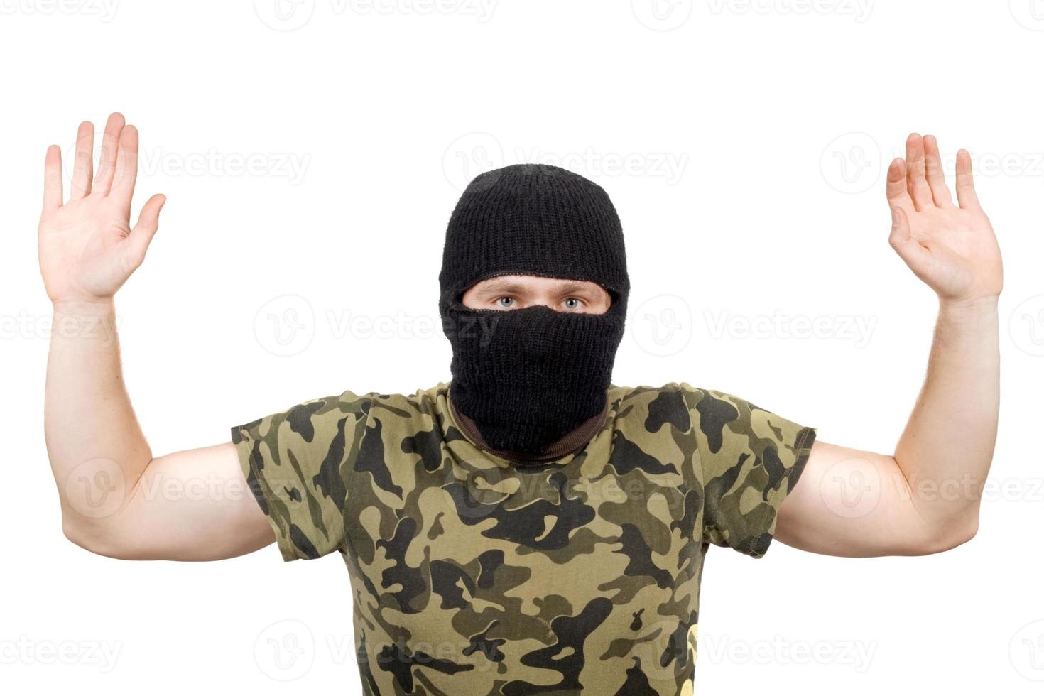 The surrendered criminal in a black mask over white photo