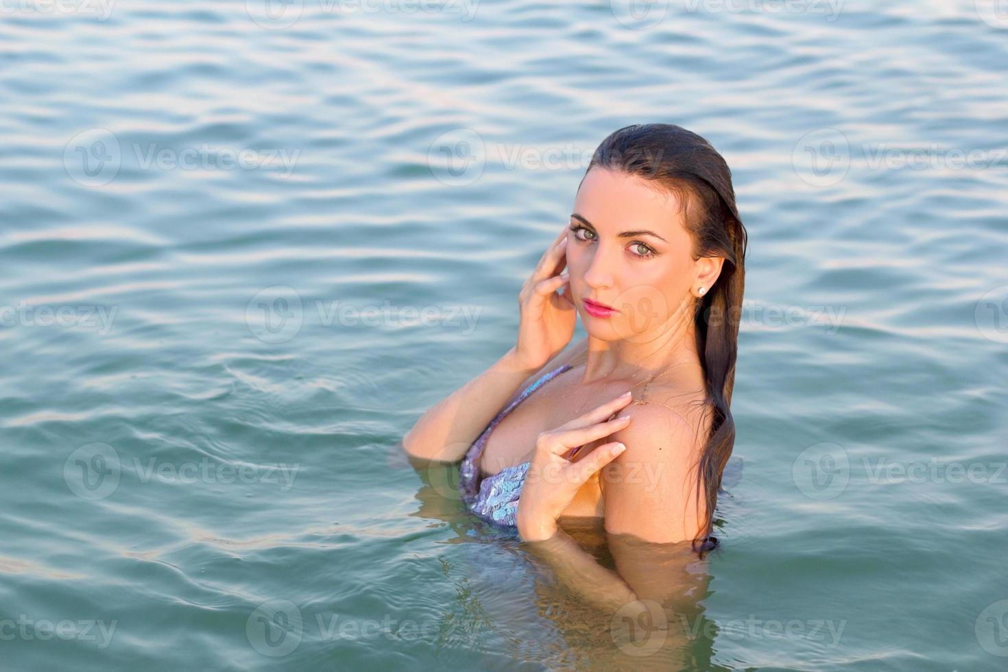 wet young woman in the water photo