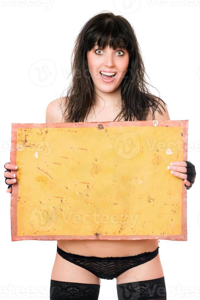 Surprised brunette taking vintage yellow board photo