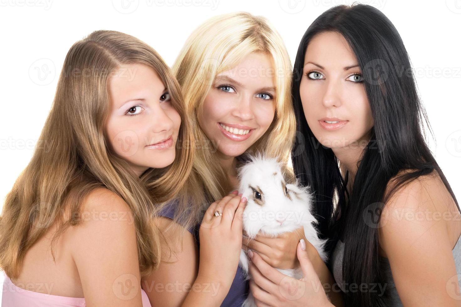 Three women with a pet rabbit photo