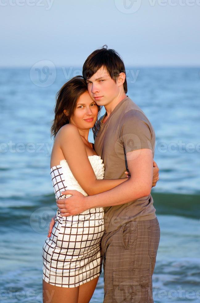 happy young couple on the beach photo