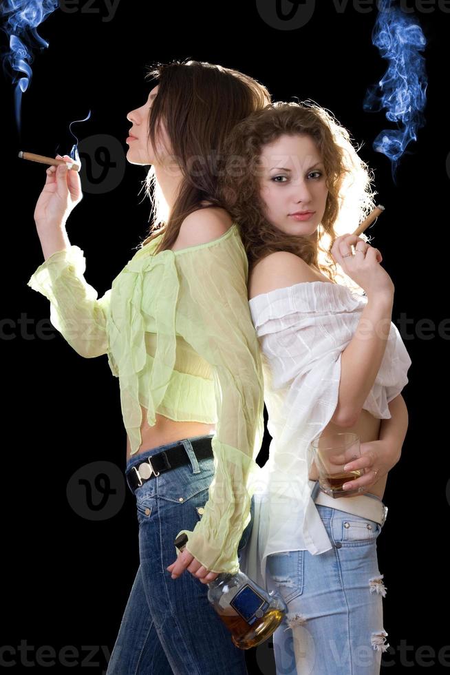 Portrait of the two girlfriends with a cognac and cigars photo