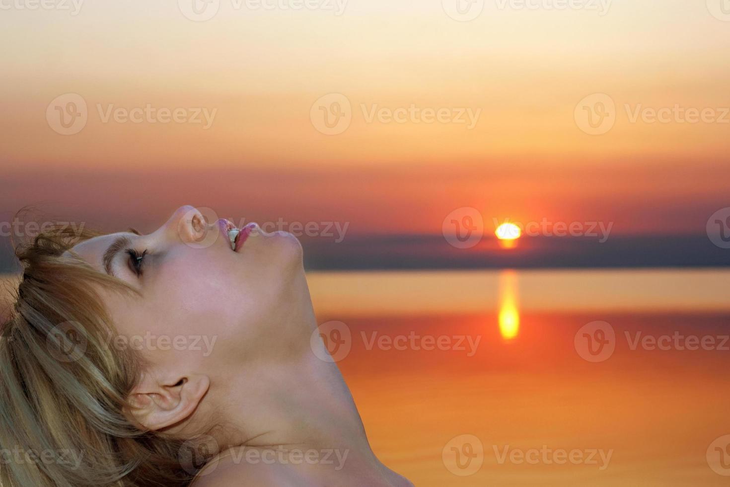 pretty young blonde at sunset photo