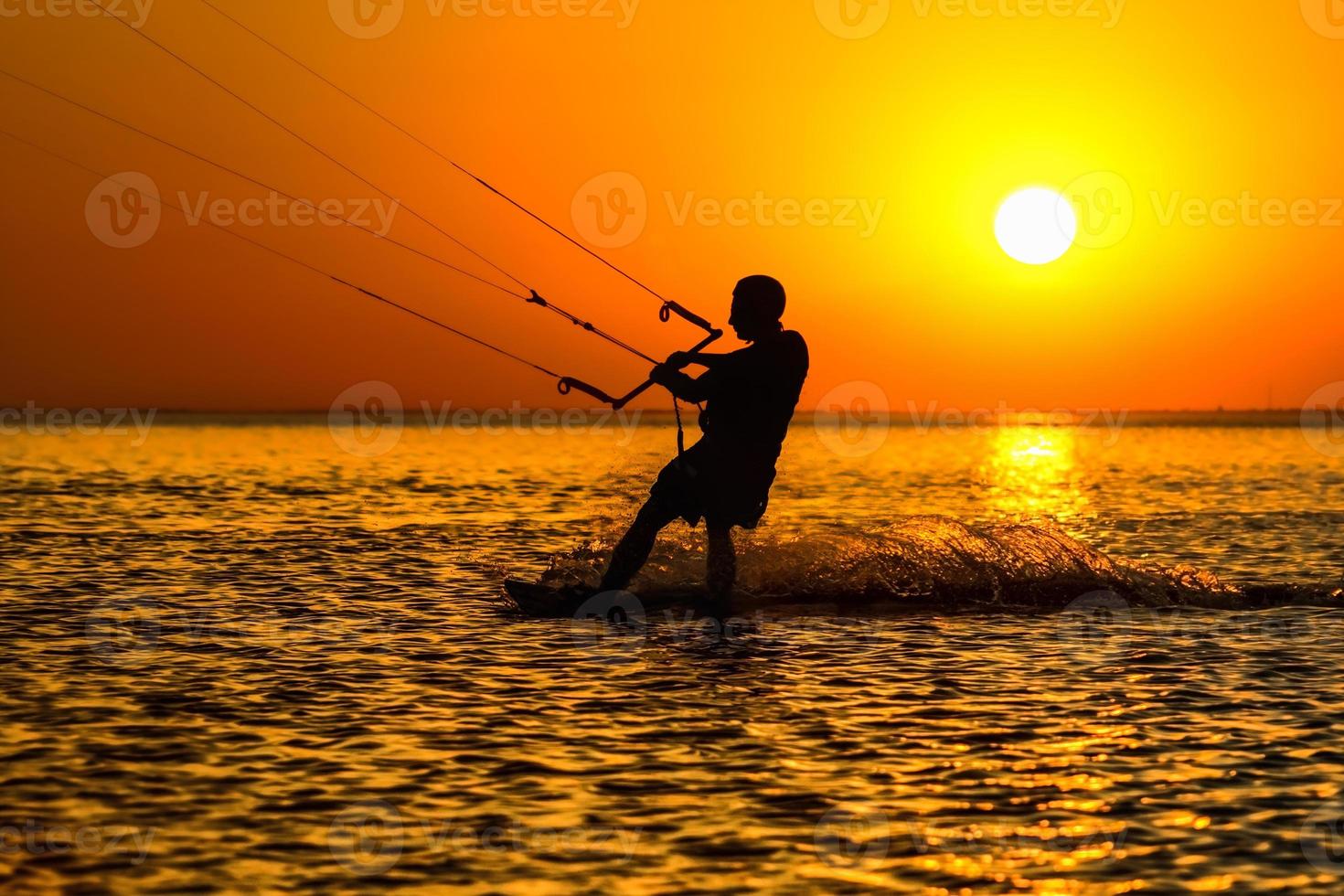 Silhouette of a kitesurfer photo