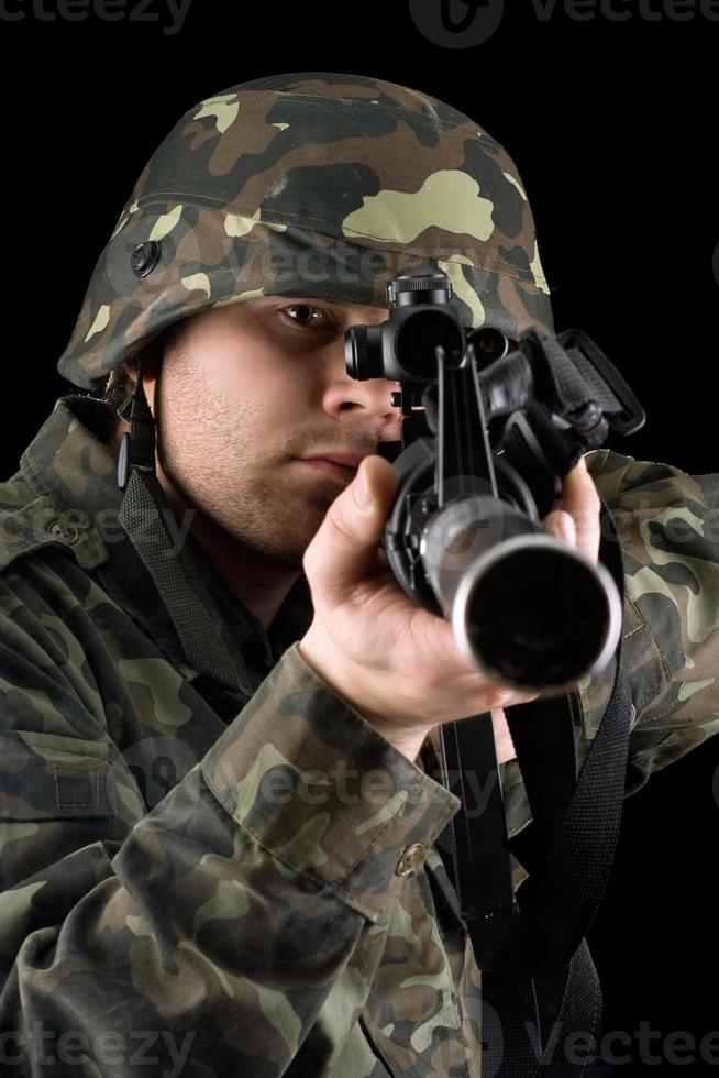 Alerted soldier pointing m16 in studio photo