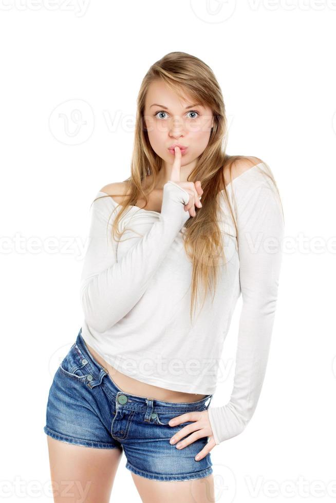 Woman shows gesture to be quiet photo