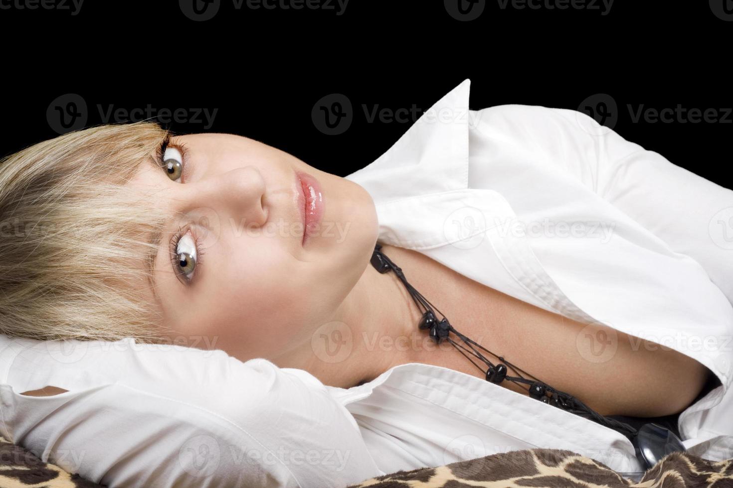 portrait of the sexy young beauty blonde lies on a bed. Isolated photo