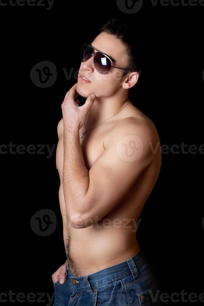 Portrait of the young man in sunglasses photo