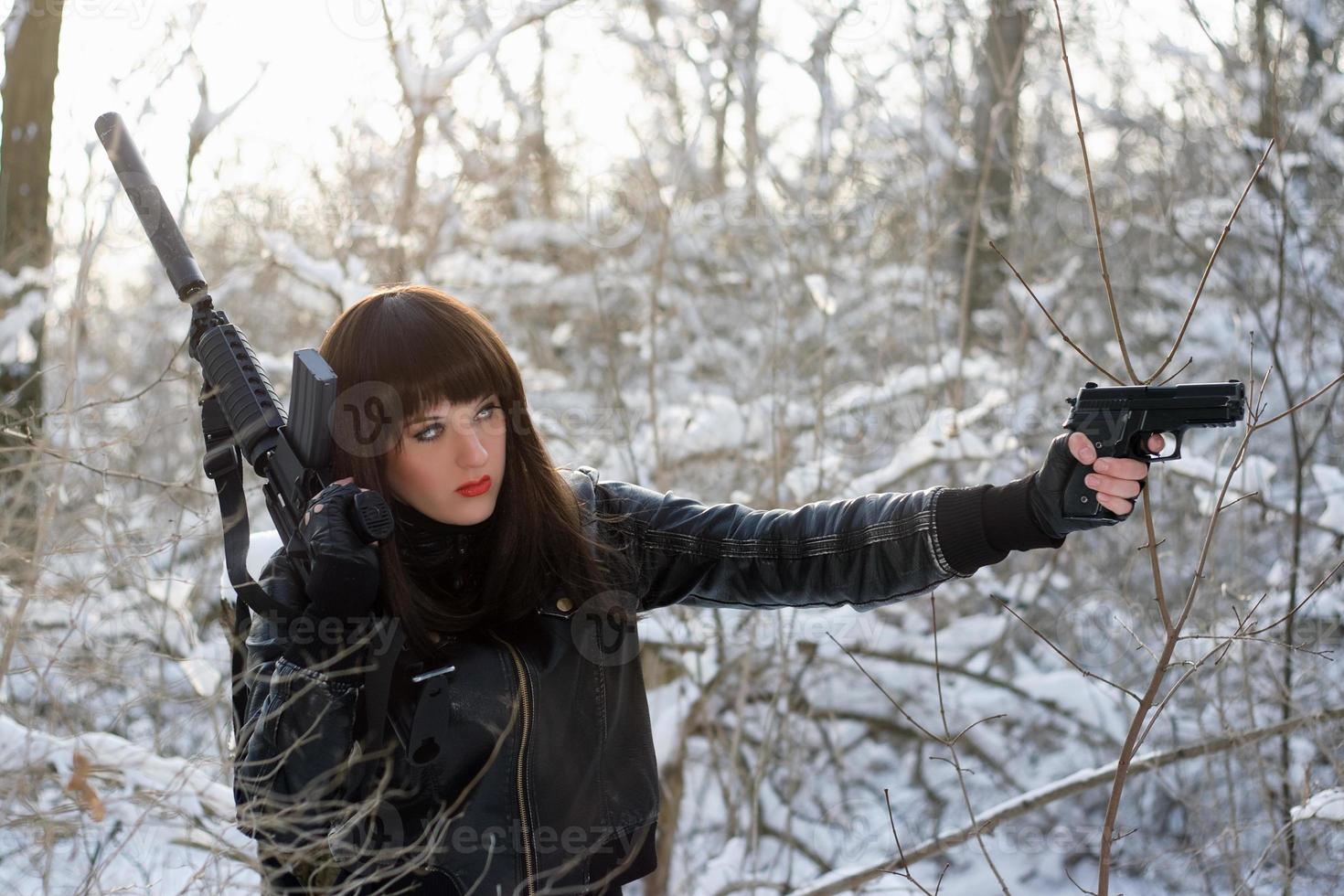 Portrait of armed sexy young lady photo