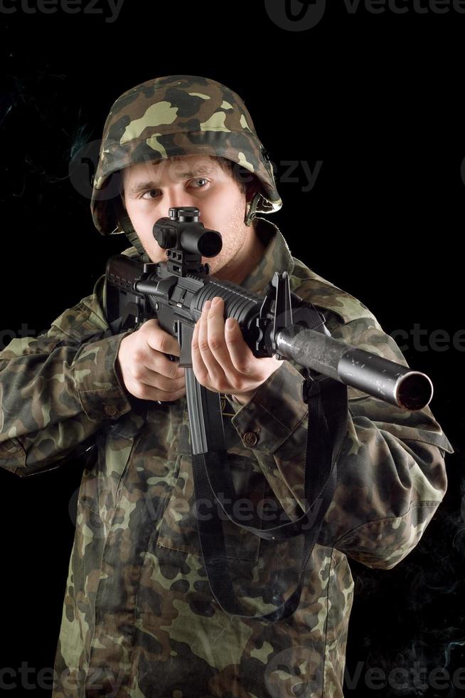 Alerted soldier keeping a gun photo