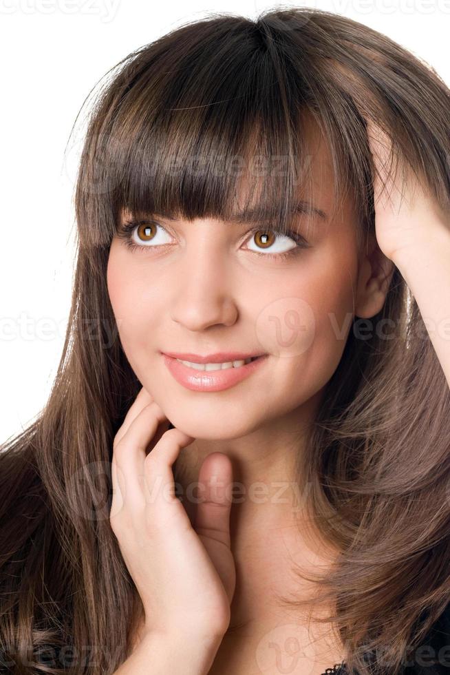 thoughtful woman with dark hair and brown eyes photo