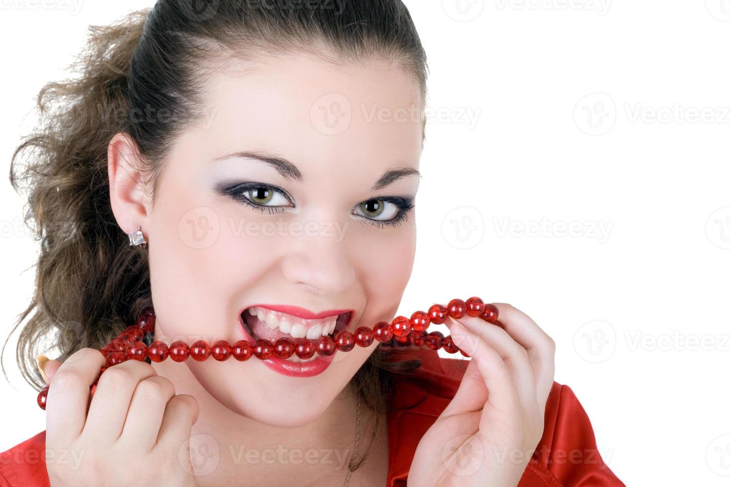 Young beautiful woman with a beads in a teeth photo