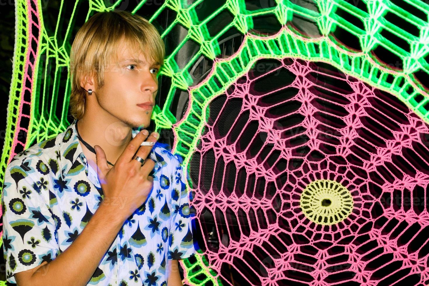 Blonde man smoking a cigarette photo