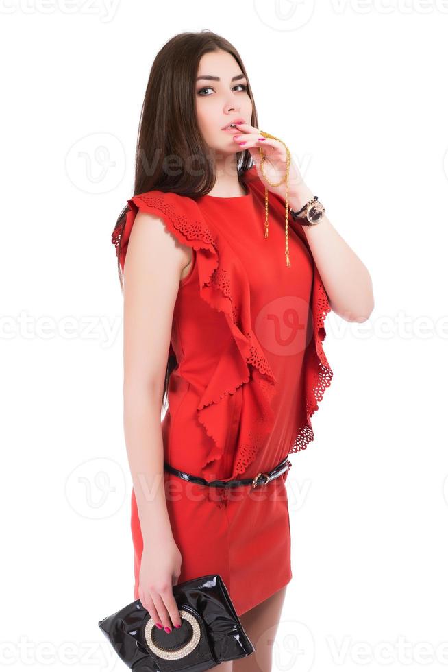 Portrait of brunette posing in red dress photo