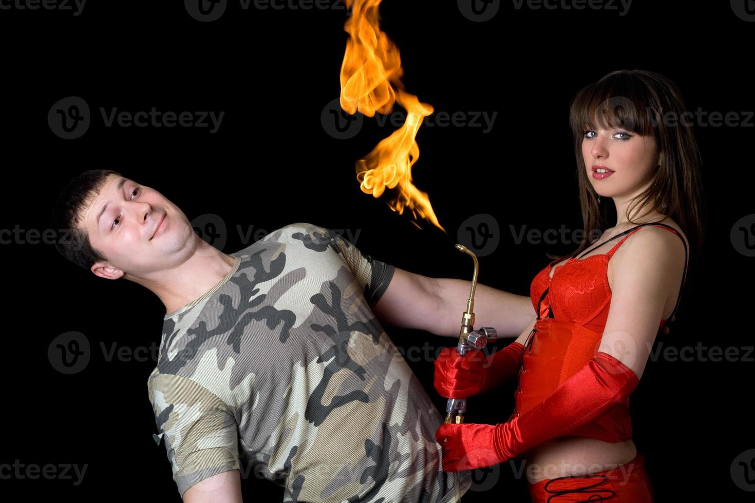 Young woman with a gas torch and scared man photo