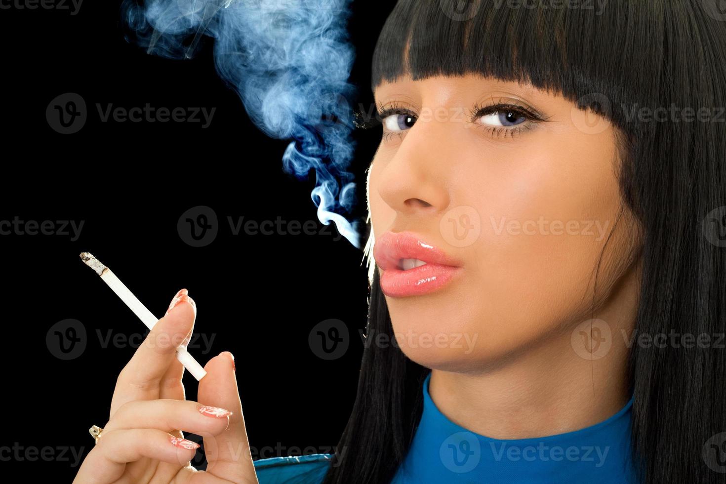 Portrait of the cute woman with a cigarette photo