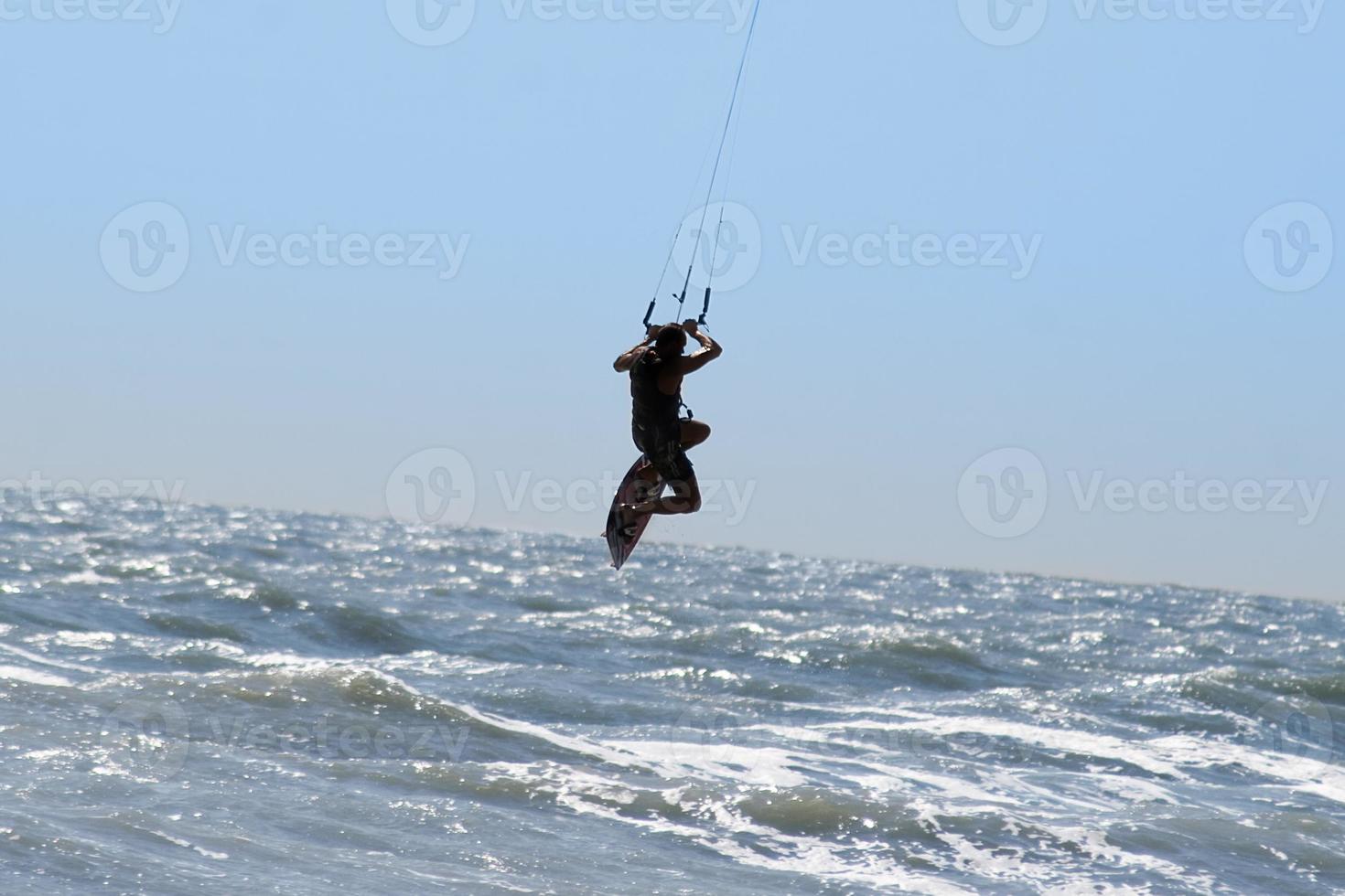 Silhouette of kite surfer photo