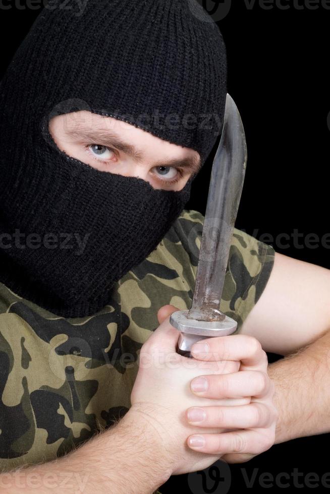 The murderer with a knife in a black mask photo