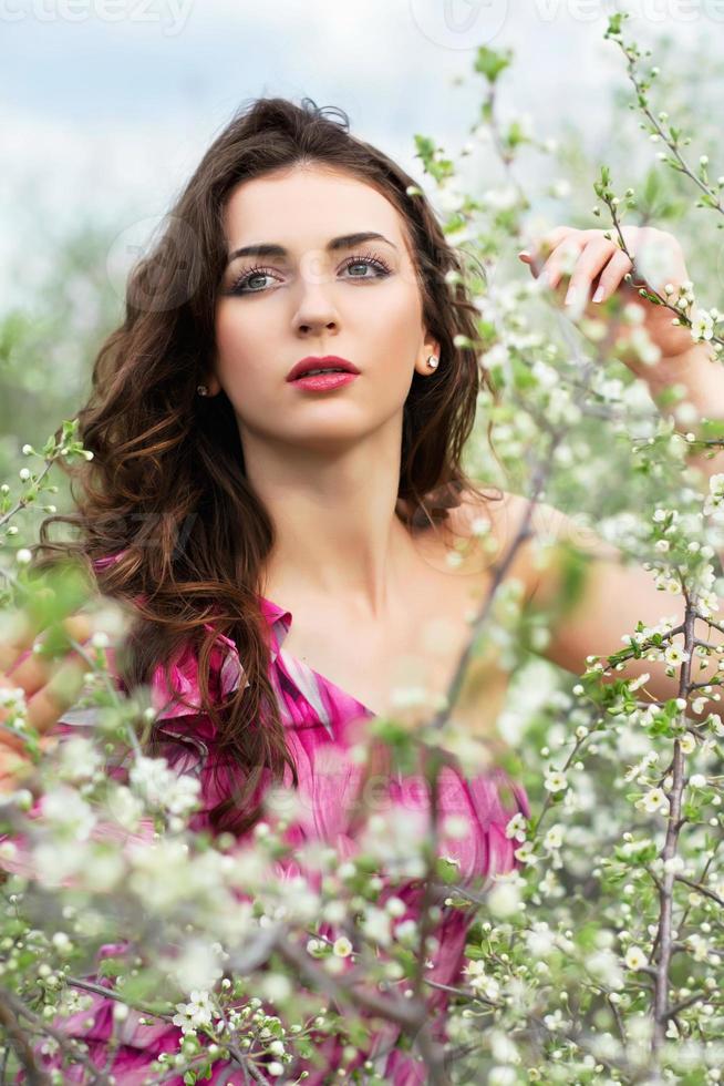 Thoughtful young curly brunette photo