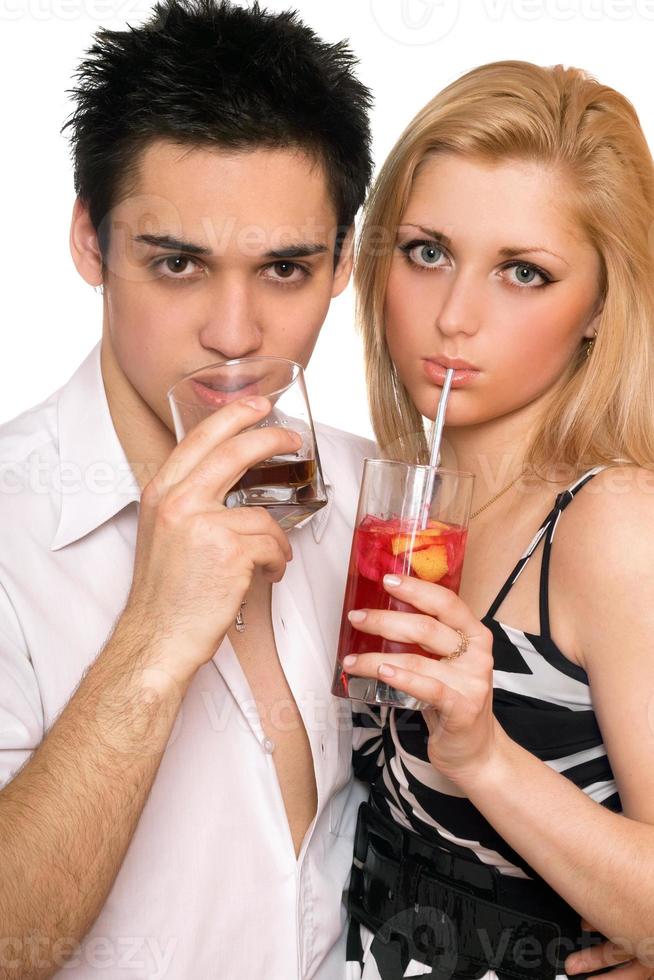 Pretty young couple with cocktails. Isolated photo