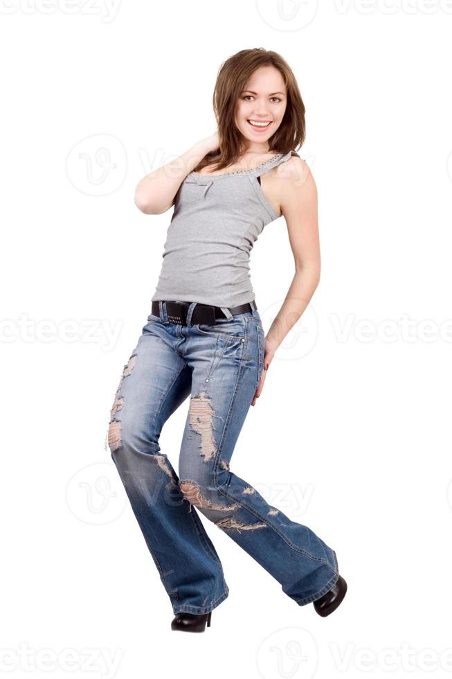 Smiling young woman in a blue jeans. Isolated photo