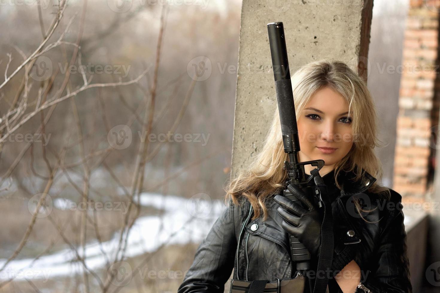 Beautiful girl with a gun photo