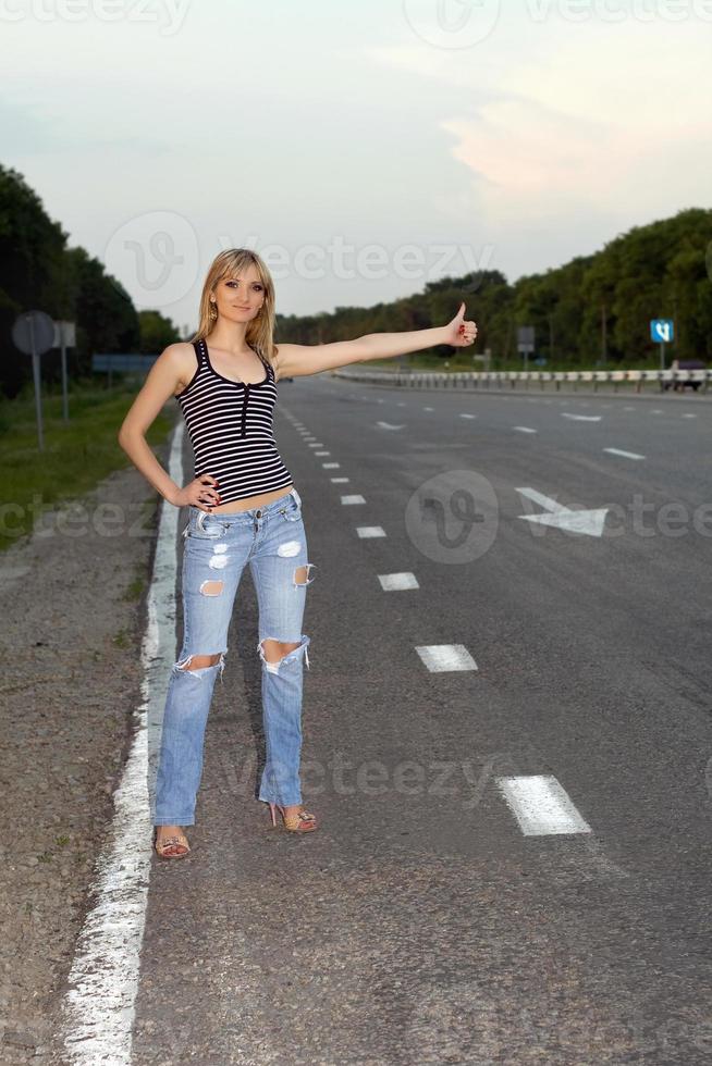 Young woman on the roadside photo