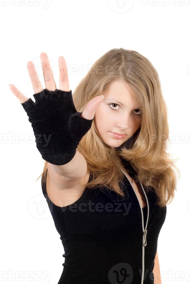 Young girl with hand stop sign. Focus on a face photo
