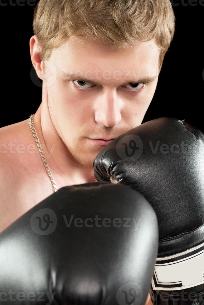 Young man in boxing gloves photo