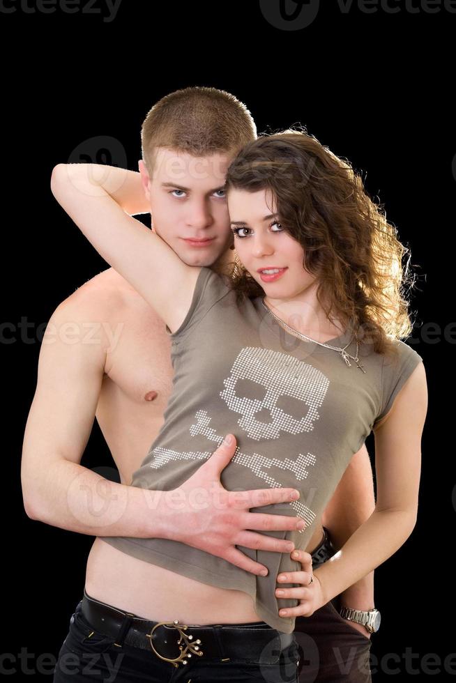 Beautiful loving young couple. Isolated on black photo