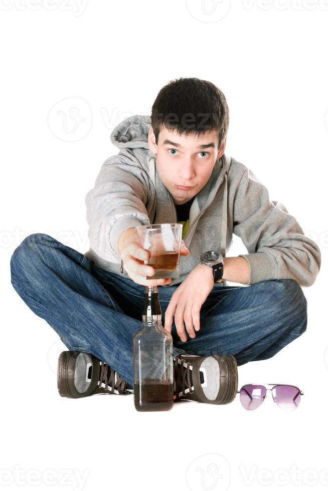 Young man with a glass of whiskey photo