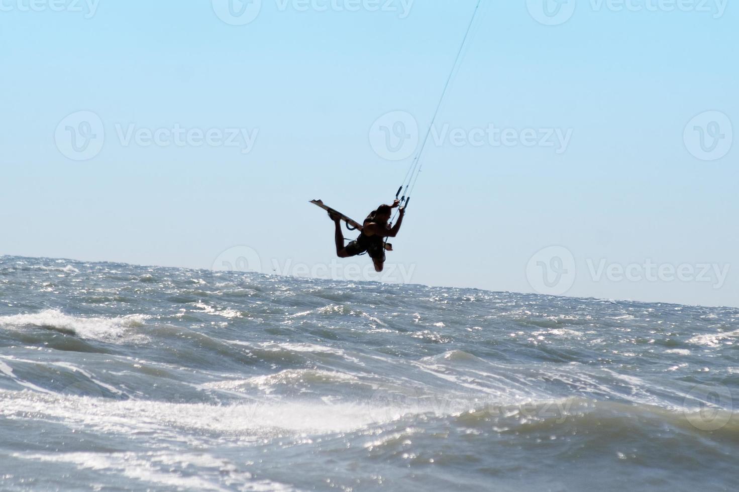 Silhouette of kite surfer photo